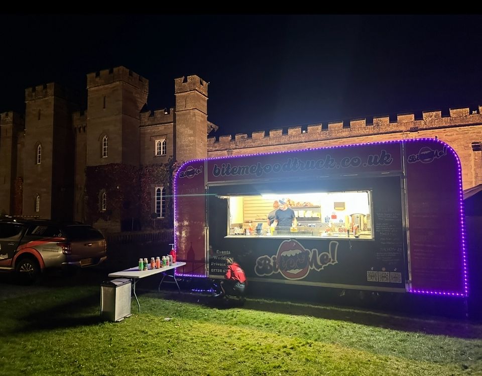 Bite Me food truck lit up at night at Scone Palace